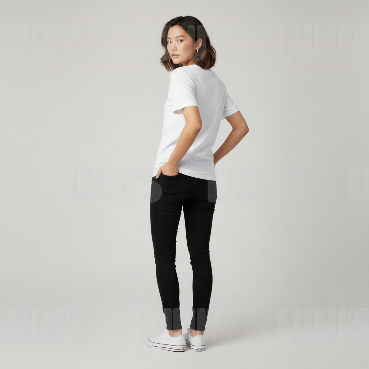 Back view of a female model wearing the white Rujinu T shirt showing plain back and casual fit.