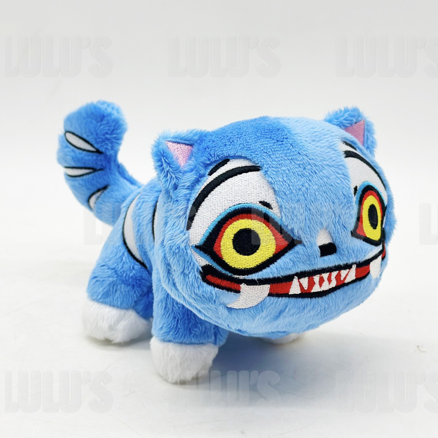 Angled front right view of Derpy Cat plush showing playful face, stitched smile, and blue fur detail.