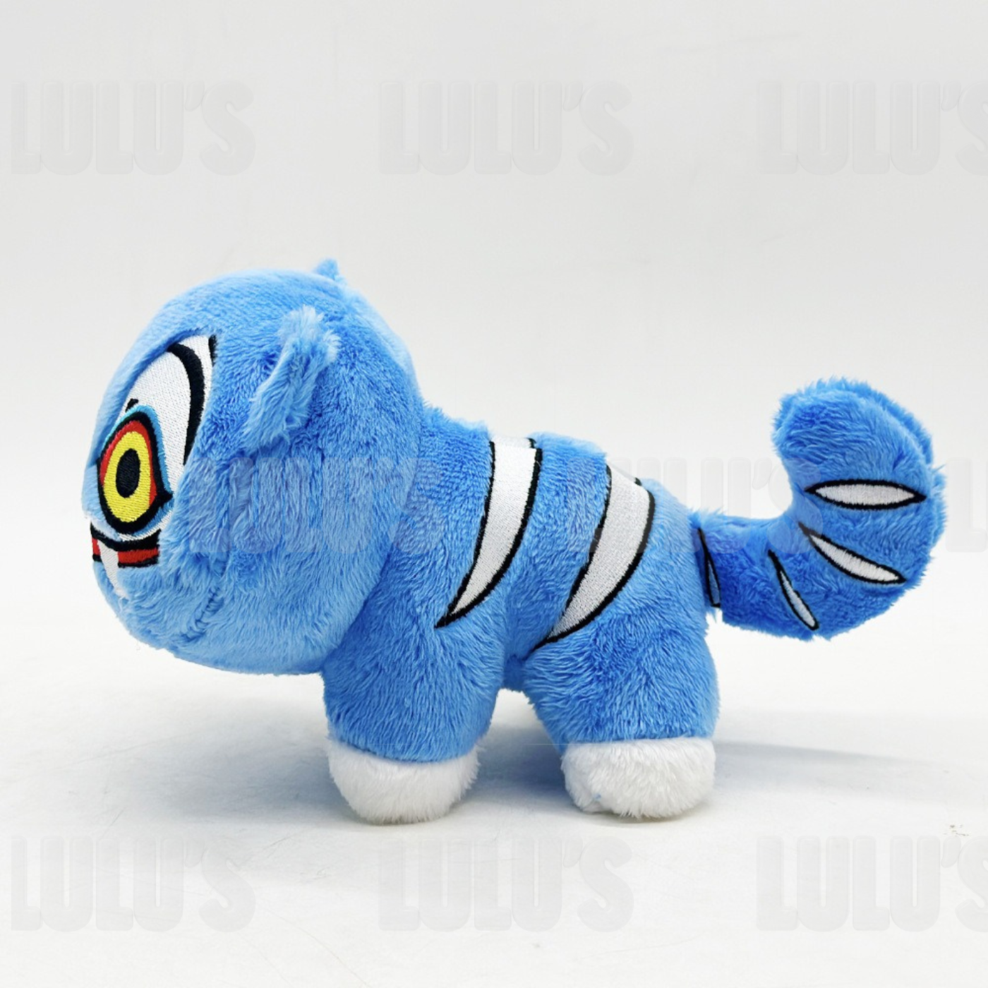 Side profile of Derpy Cat plush showing curled tail with embroidered stripes and compact soft body.
