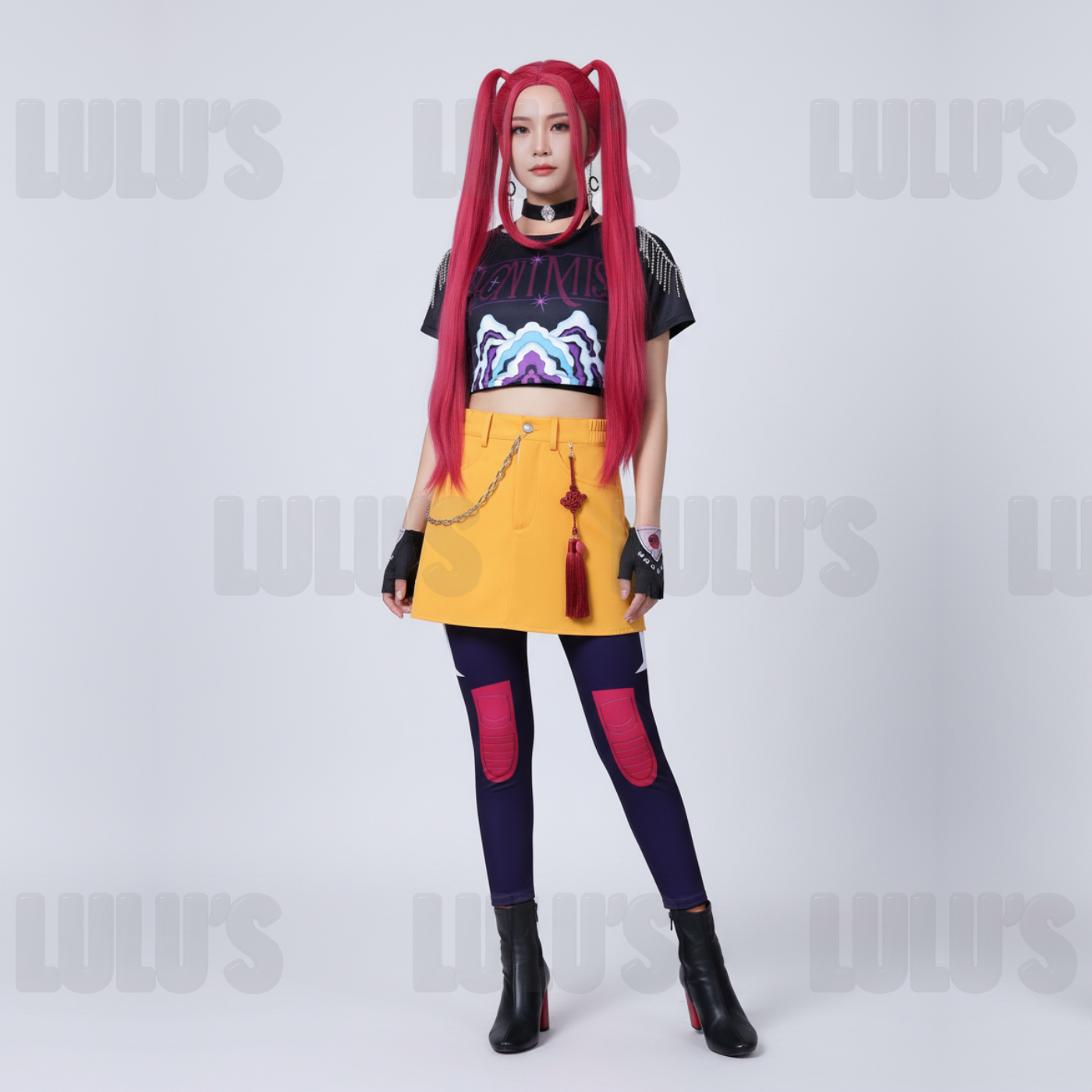 Female model wearing K-Pop Demon Hunters Mira cosplay costume with red twin-tail wig, black printed crop top, yellow skirt, purple leggings, black gloves, and heeled boots.